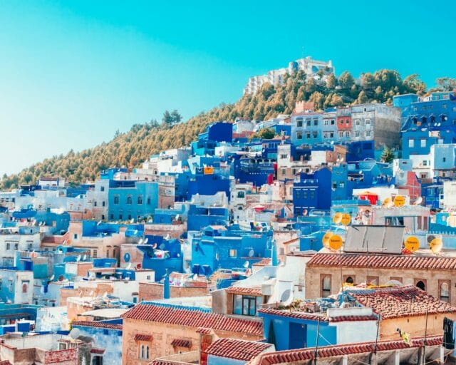 blue and white painted houses on the cliff